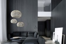 24 a double height monochrome space with black wood walls and French parquet