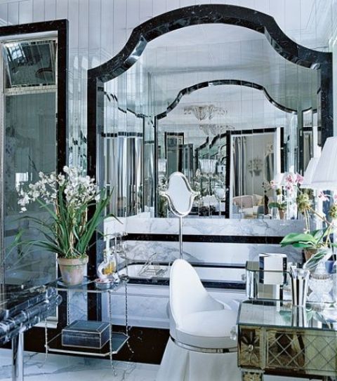 lots of mirror and glass makes the space more glam and sparkling, and silver touches add style