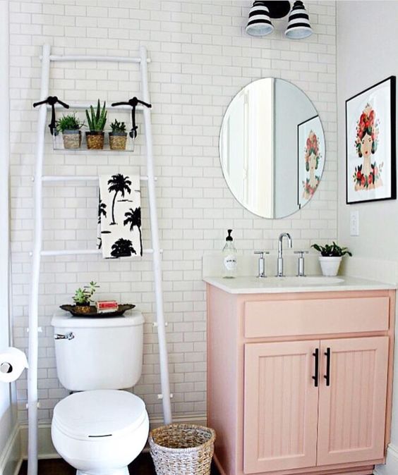 a pink vintage cabinet with a white top adds color and a cool look to the powder room