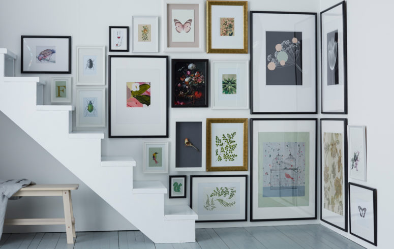 a staircase corner is fully taken with artworks and looks very spectacular, what a great idea
