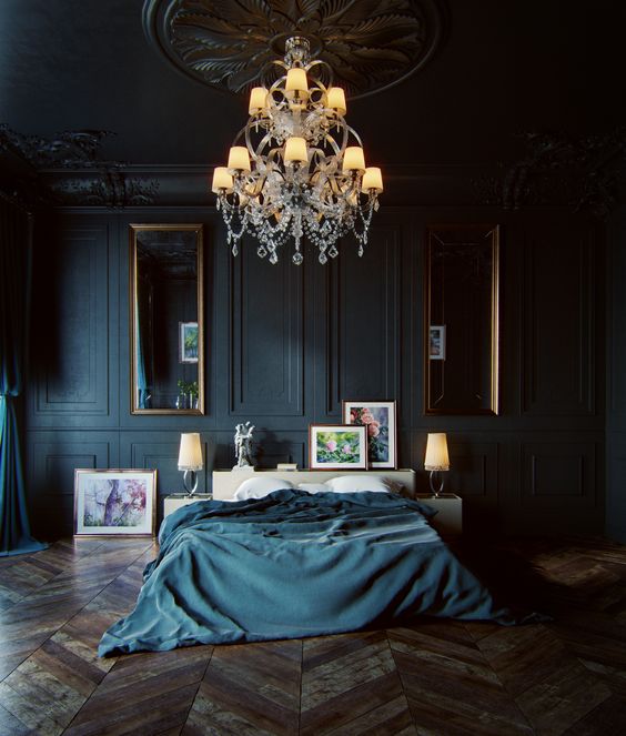 a moody luxurious bedroom with black panel walls, vintage mirrors and a chandelier and stunning parquet floors
