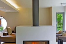 26 a wood burning closed stove visible from both sides is a gorgeous modern idea to bring warmth