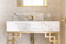 27 a very eye-catching marble vanity with gilded geometric legs and framing looks wow