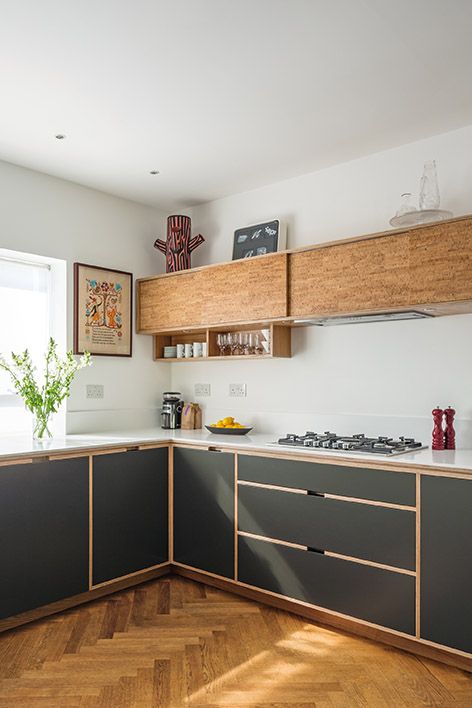 graphite grey and wooden cabinets are tied with the help of wooden framing on the grey lower cabinets