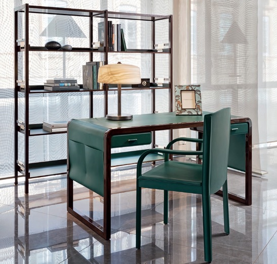 The Jolie Desk By Armani Casa is a refined and chic desk made of green leather and dark elm wood and features beautiful shapes and lines