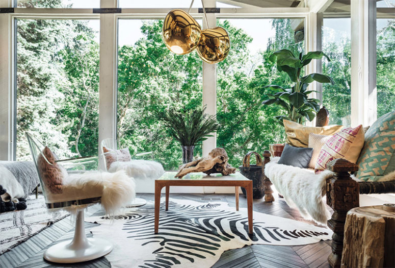 The nook is defined with unobtrusive views, brass pendant lamps, acrylic chairs and some wood items