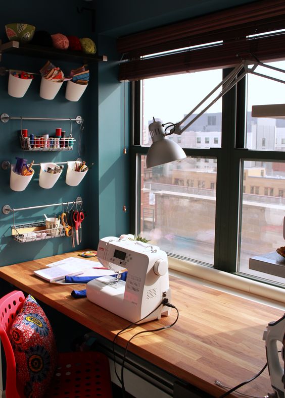 a small window sill crafting nook with rails for various stuff and lots of natural light