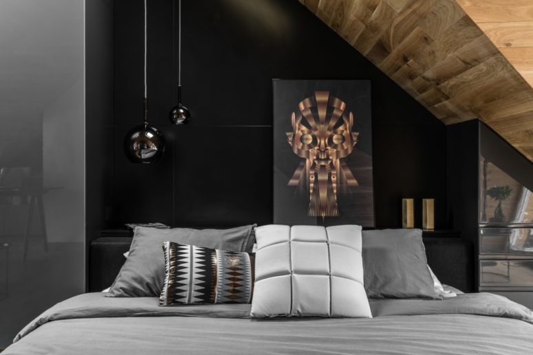 Eye-catchy pendant lamps add to the style, and built-in cabinets function as a wardrobe and just a storage piece