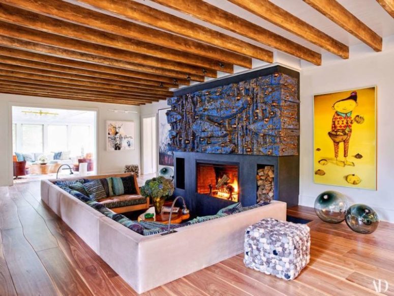 The living room features a sunken conversation pit and a unique fireplace done by an artist