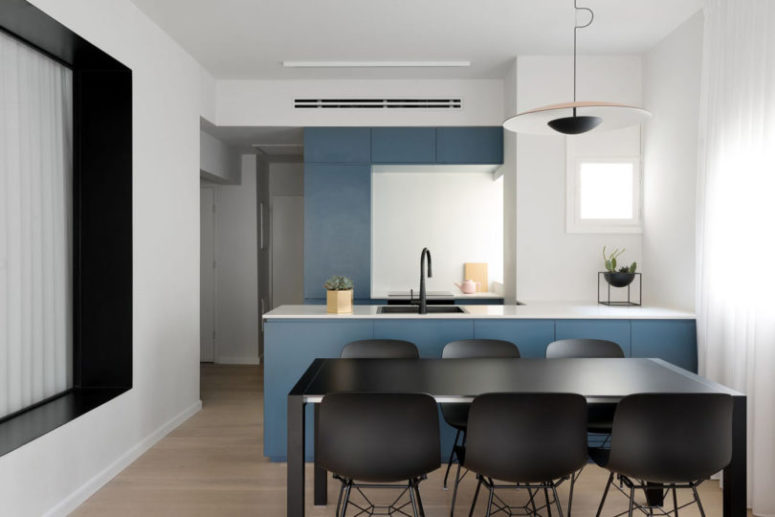 Windows everywhere, even in the small kitchen, flood the space with natural light
