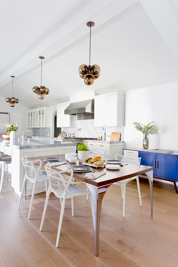A breakfast space is right next to the kitchen island, there's a metal table