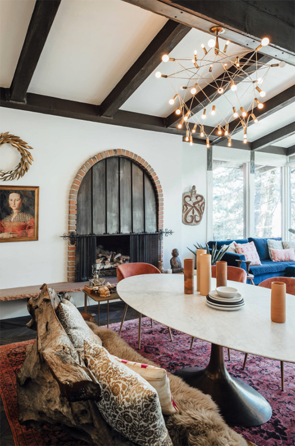 A metal and brick built-in hearth and a wooden slab bench covered with faux fur make the space amazing