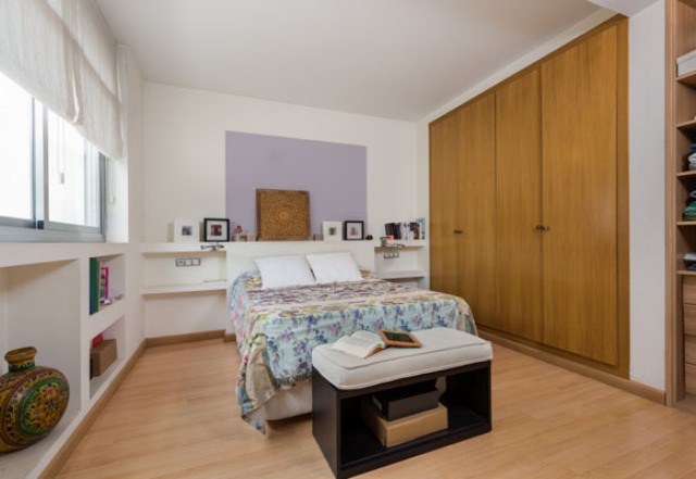 The master bedroom is done with much built-in storage, a large wardrobe and a lavender touch