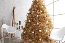 04 a gold Christmas tree decorated with white ornaments is great for a glam space