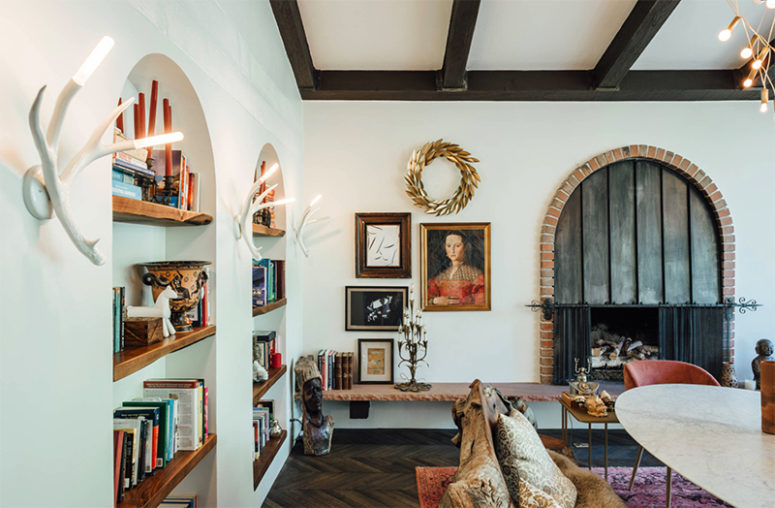 The antler-styled wall lamps, vintage artworks and some accessories make the space unique