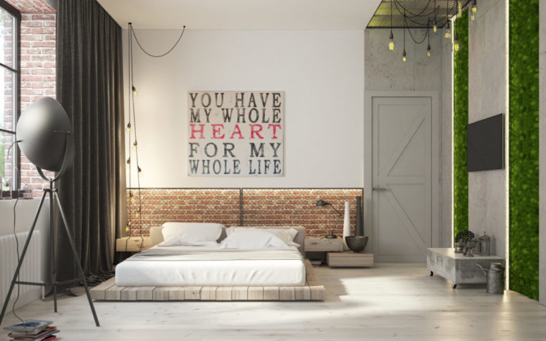The bedroom shows off urban aesthetic with an exposed brick headboard wall and a vertical garden