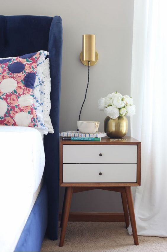 a tube shaped brass sconce is always a good idea for many different bedroom styles