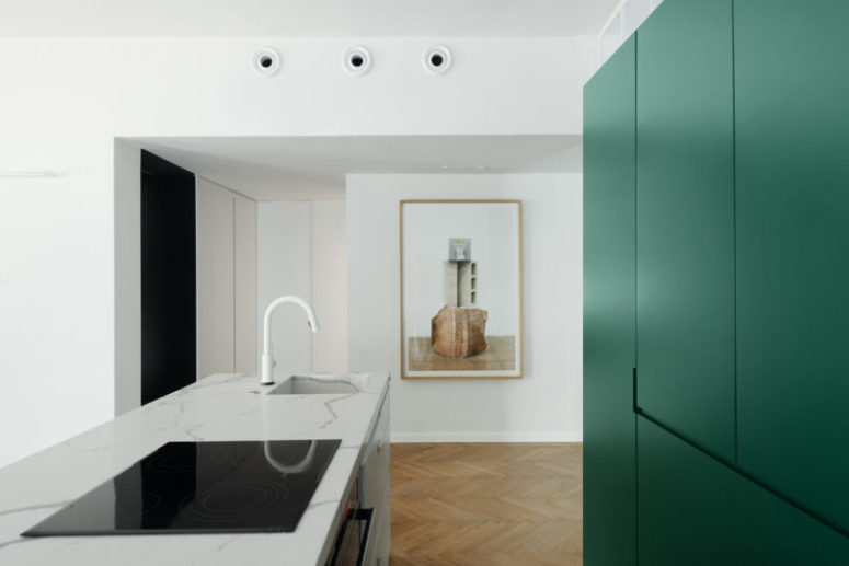 The countertop is done of marble and there's a very eye-catching artwork to make the space look bold and chic
