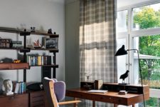The home office breathes with mid-century modern vibes, there’s a comfy storage unit and a vintage desk