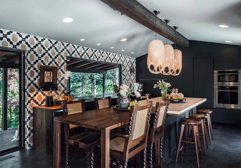 The kitchen is Gothic, there's a geometric walpaper wall and sleek matte black cabinets