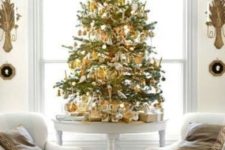 06 a small tabletop Christmas tree with gold and white ornaments looks contrasting and festive