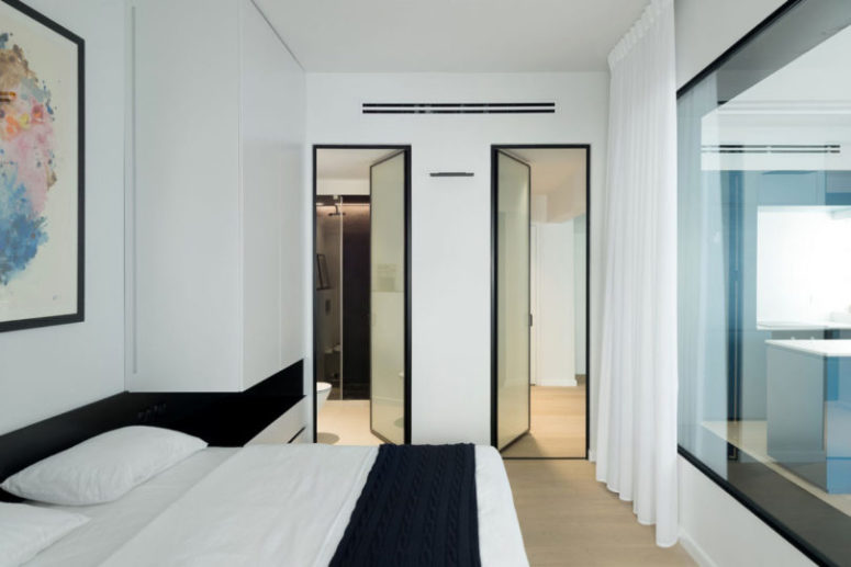 There's a large window to the living room to unite the spaces when needed and give them an ethereal feel