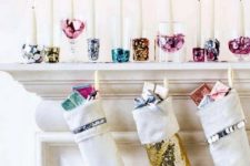 07 a glam display with shiny colorful candle holders and sequin stockings plus colorful gifts