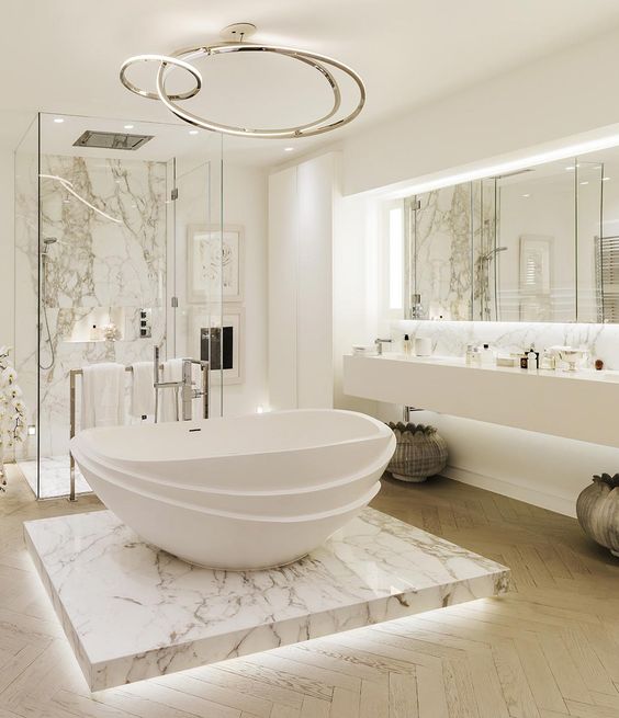 a marble shower and a bathtub platform with additional lights for a chic feel
