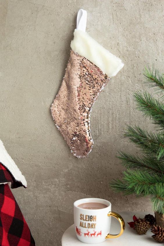 a rose gold sequin stocking with white faux fur on top looks very glam and cute