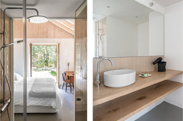 The master bathroom features neutral tiles and natural wooden shelves