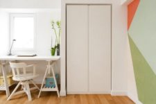 08 The workspace is done with a white trestle table and a sleek storage unit