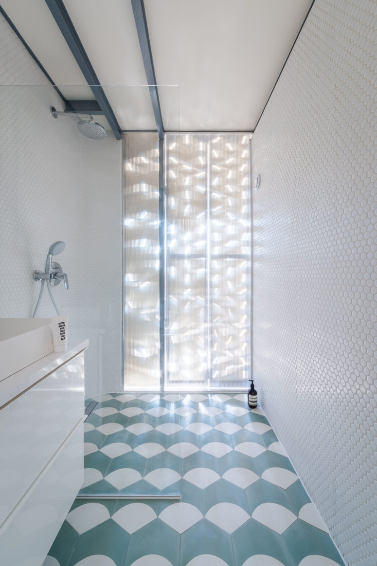 tiles lon a bathroom floor with an interesting pattern There's also an en-suite bathroom clad with white penny tiles and with a geo tiled floor