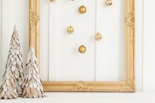 09 a vintage gold frame with gold ornaments hanging inside is a great decoration to make