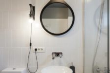 10 The bathroom is also monochromatic and sleek, with black touches