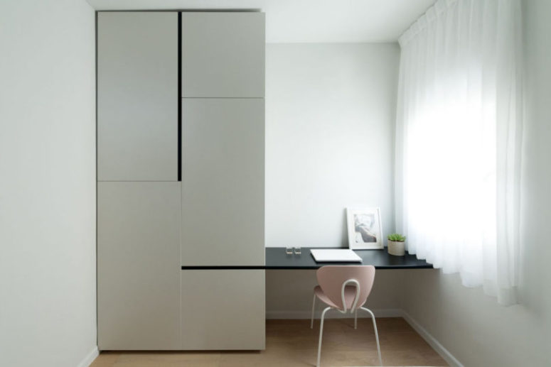 The workspace is a small one, with a desk attached to the wardrobe and a pink chair