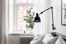 10 a black sconce is great for a Scandinavian or modern space with a simple color palette