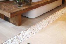 10 pebbles in between the floor tiles, a wooden bench and potted succulents will create a relaxing ambience