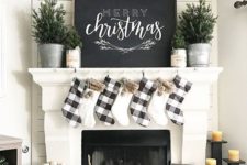 11 plaid and faux fur stockings, evergreen trees in pots and a large chalkboard sign for a cozy neutral look