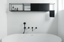 12 There’s a bathroom with a large free-standing bathtub and a hanging shelf unit for storage