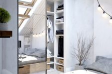 12 a Scandinavian bedroom with an attic closet, which is separated with a mirror barn door