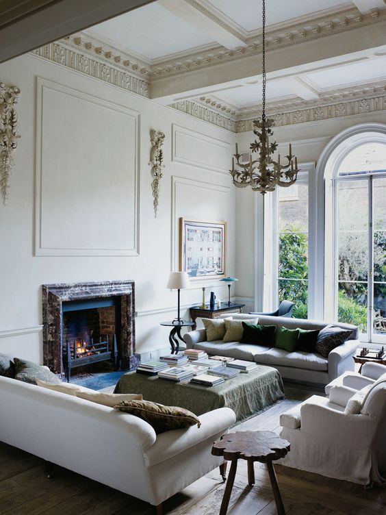 a built-in fireplace clad with marble makes this space special and cozy