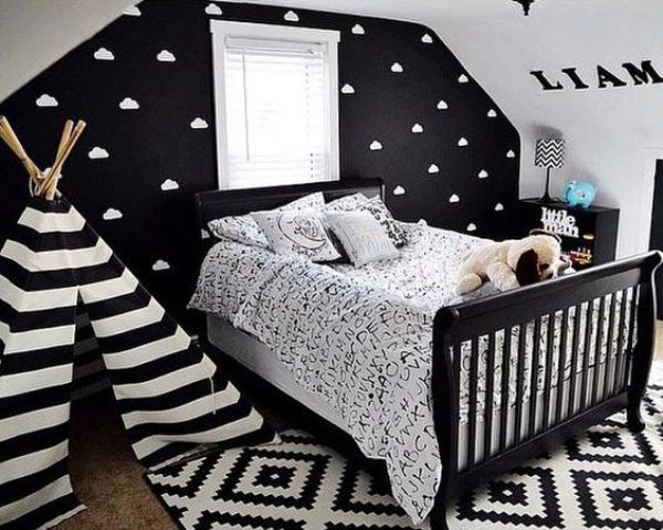 a black statement wall with a cloud print makes the space more eye-catching