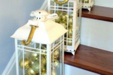 14 white lanterns filled with gold and gold glitter ornaments are great for marking the steps