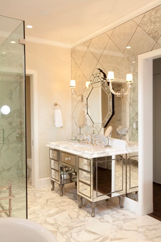 a vintage-styled mirror bathroom vanity, an antique mirror statement wall and a mirror on it
