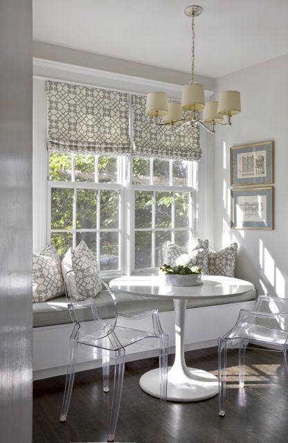 a window sill bench with a cushion, a small table and a couple of acrylic chairs for an ethereal nook