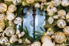 16 an evergreen wreath with gold and silver ornaments is a timeless idea for a front door