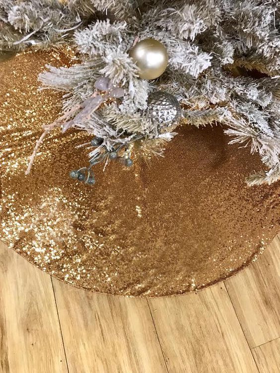 a gold sequin tree skirt looks very glam and is ideal to cover the base of your tree