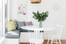 17 a simple and cute breakfast nook with an upholstered bench, a round table and chairs