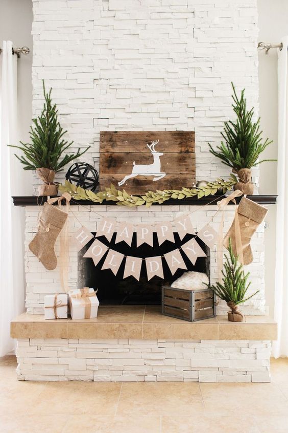 a felt leaf garland, a deer sign, evergreen trees in burlap and burlap stockings