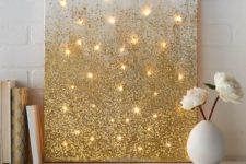 19 a glitter gold artwork with lights is an easy DIY to make